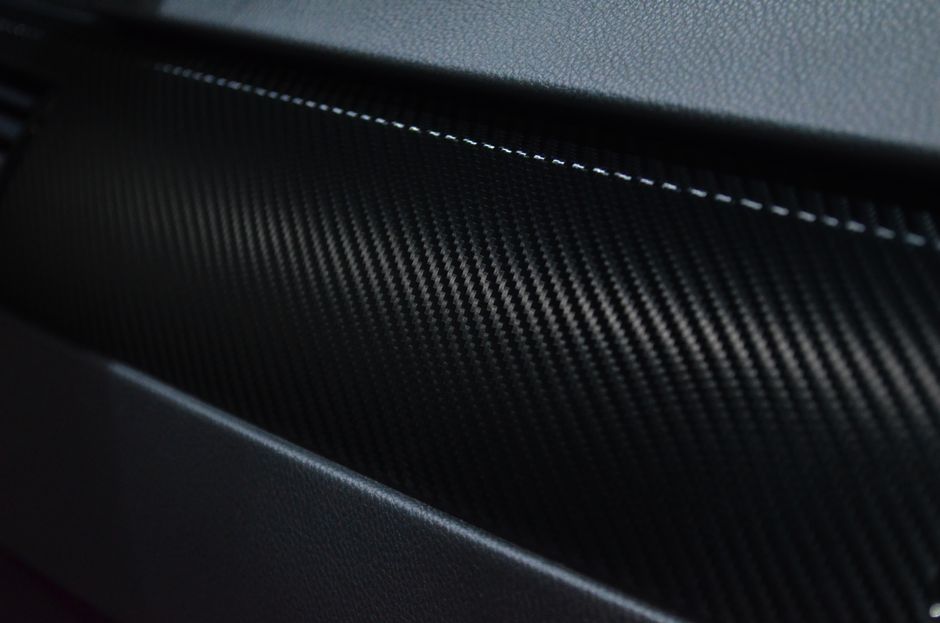 Detailed view of a carbon fiber texture on a car interior showcasing modern design.