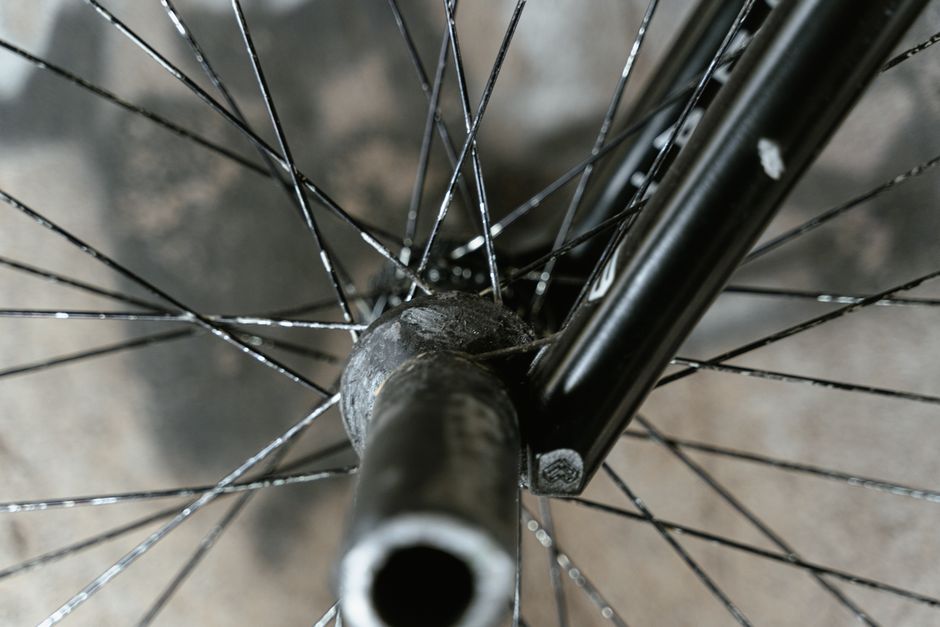 Intricate close-up view of a bicycle wheel hub with polished spokes.